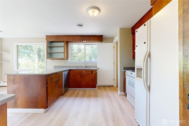 kitchen with a sink, open shelves, white appliances, light wood-style floors, and a baseboard radiator