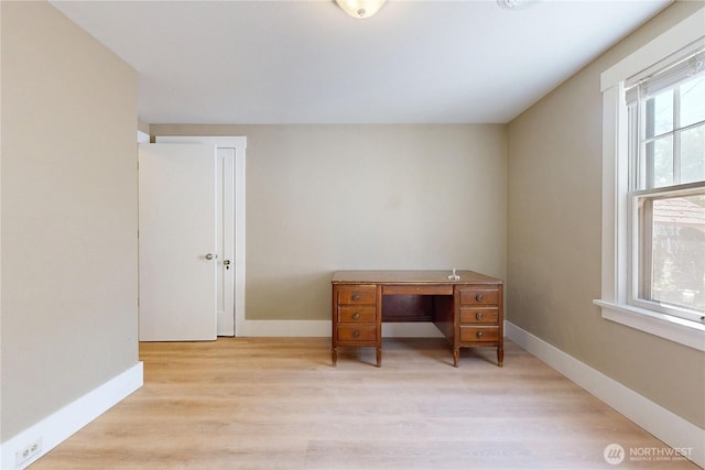office area featuring baseboards and light wood-style flooring