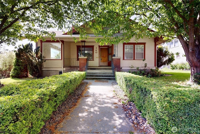 bungalow with a porch and driveway
