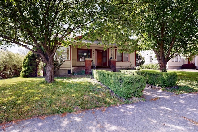 view of front of home featuring a porch and a front lawn