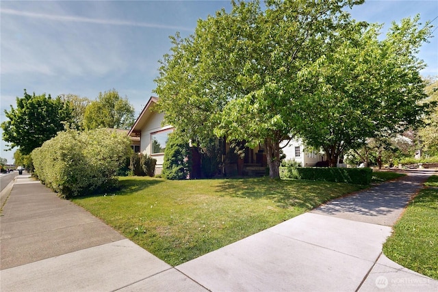 view of side of home featuring a lawn