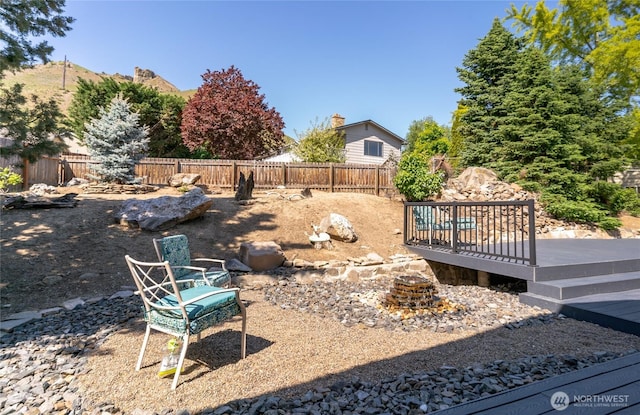 view of yard with a wooden deck and a fenced backyard