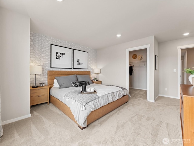 carpeted bedroom featuring a closet, baseboards, a walk in closet, and recessed lighting