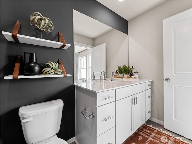 bathroom with toilet and vanity