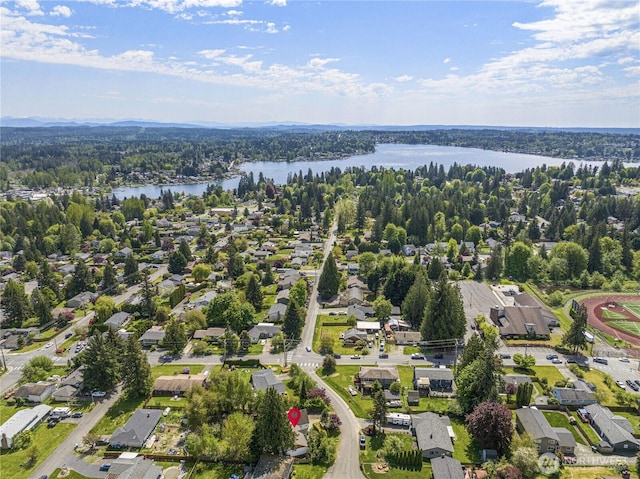 view of property location with a large body of water and nearby suburban area