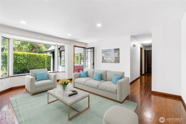 living room with baseboards, hardwood / wood-style flooring, and recessed lighting