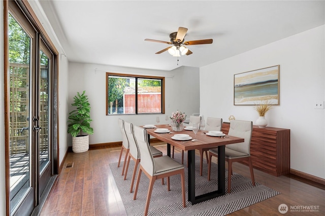 dining area with baseboards, hardwood / wood-style floors, and a ceiling fan