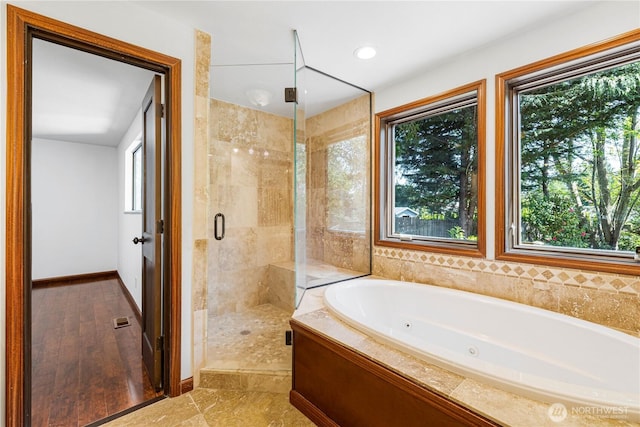 bathroom with plenty of natural light and a stall shower