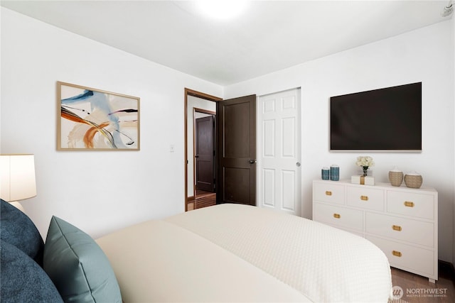 bedroom with dark wood-type flooring