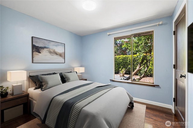 bedroom featuring wood finished floors and baseboards