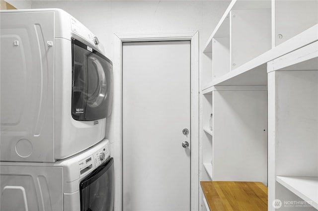 washroom with stacked washing machine and dryer