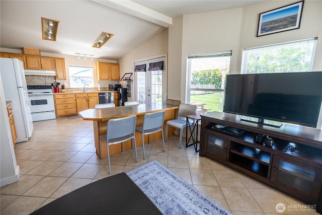 878 SW Hunter Ave, Quincy, WA 98848 - kitchen with white appliances, under cabinet range hood, light tile patterned floors, light countertops, and a sink