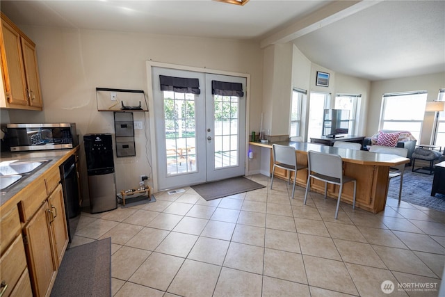 878 SW Hunter Ave, Quincy, WA 98848 - kitchen with stainless steel microwave, french doors, light tile patterned floors, open floor plan, and a peninsula