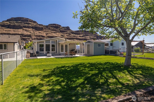 878 SW Hunter Ave, Quincy, WA 98848 - rear view of property with a storage shed, french doors, an outbuilding, a patio, and a mountain view