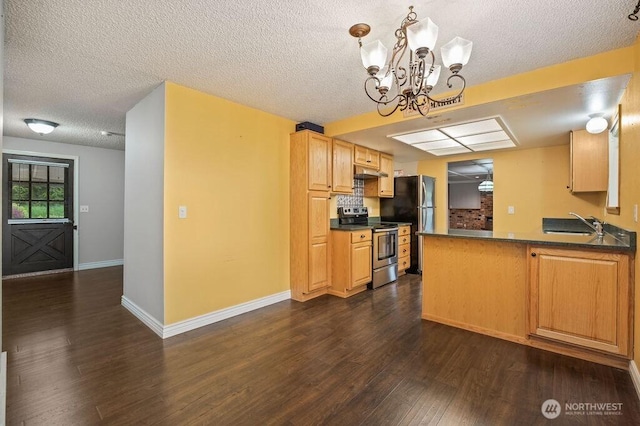 17919 3rd Ave NE, Arlington, WA 98223 - kitchen featuring stainless steel appliances, dark countertops, dark wood-type flooring, a chandelier, and a textured ceiling