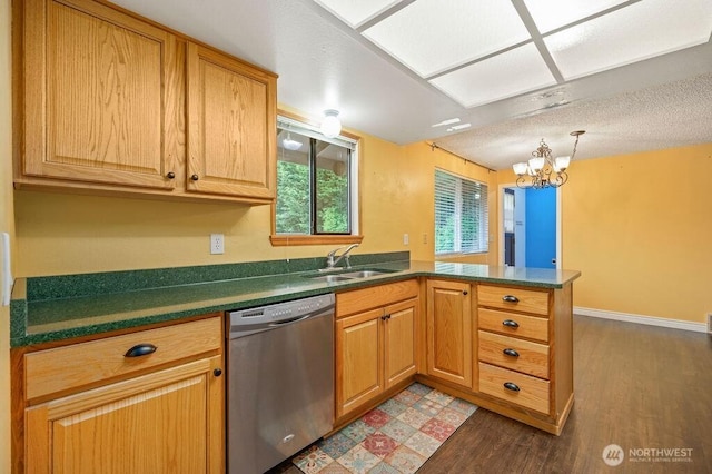17919 3rd Ave NE, Arlington, WA 98223 - kitchen with stainless steel dishwasher, a sink, a peninsula, wood finished floors, and dark countertops