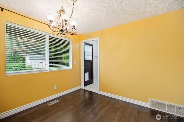 17919 3rd Ave NE, Arlington, WA 98223 - spare room featuring a chandelier, a textured ceiling, wood finished floors, and baseboards