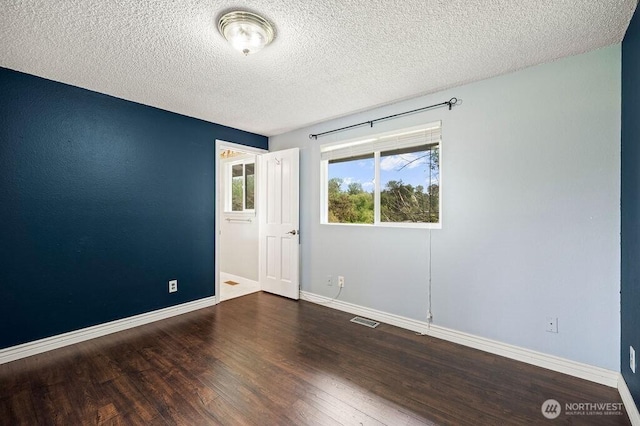 17919 3rd Ave NE, Arlington, WA 98223 - unfurnished room featuring wood finished floors, baseboards, and a textured ceiling