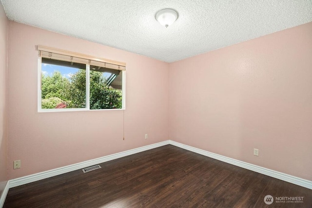 17919 3rd Ave NE, Arlington, WA 98223 - unfurnished room with dark wood-style floors, baseboards, and a textured ceiling