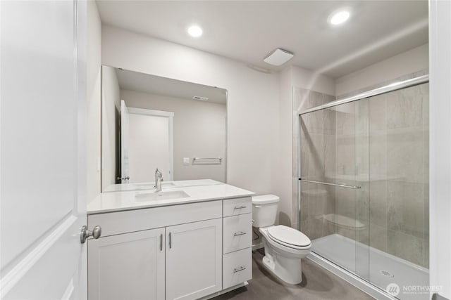 full bath featuring a shower stall, recessed lighting, vanity, and toilet