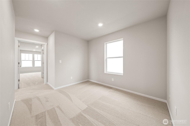 spare room with light carpet, baseboards, and recessed lighting