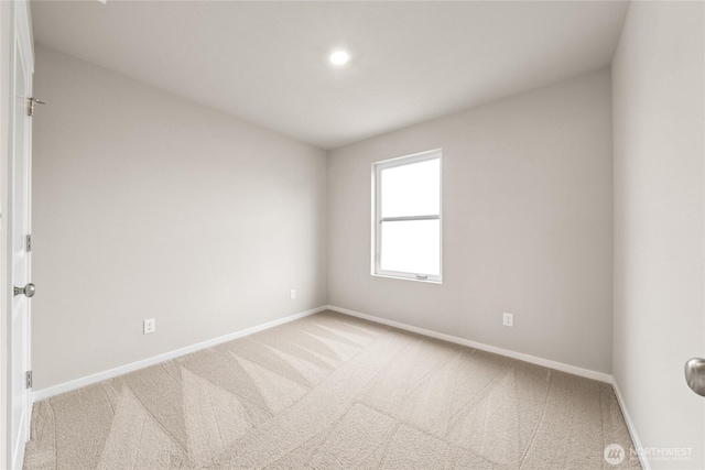 empty room featuring baseboards and carpet floors