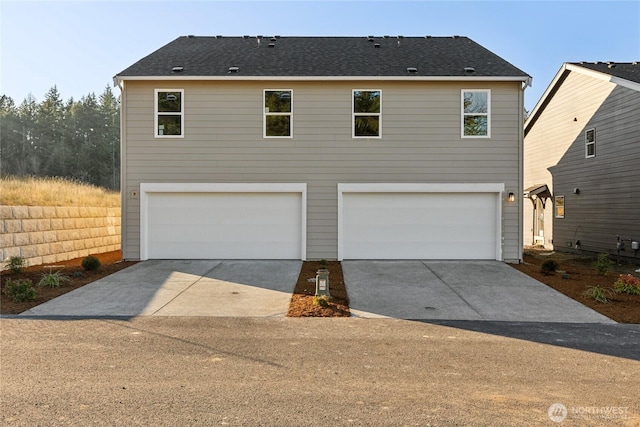 view of front of home with an attached garage and concrete driveway