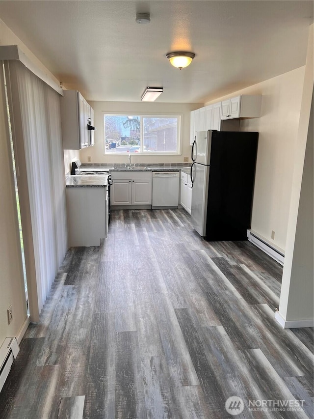 kitchen featuring stainless steel appliances, a baseboard radiator, wood finished floors, and a sink