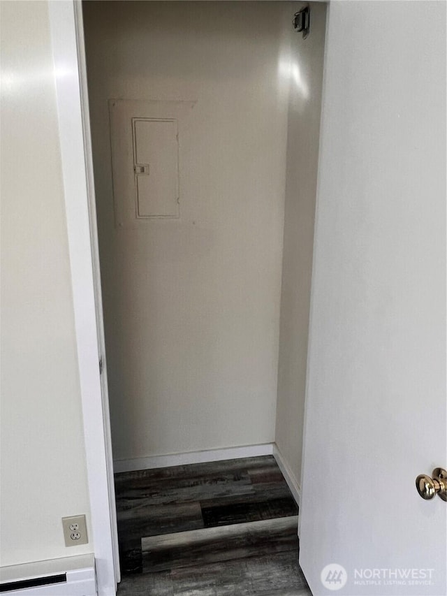 hall featuring wood finished floors and baseboards