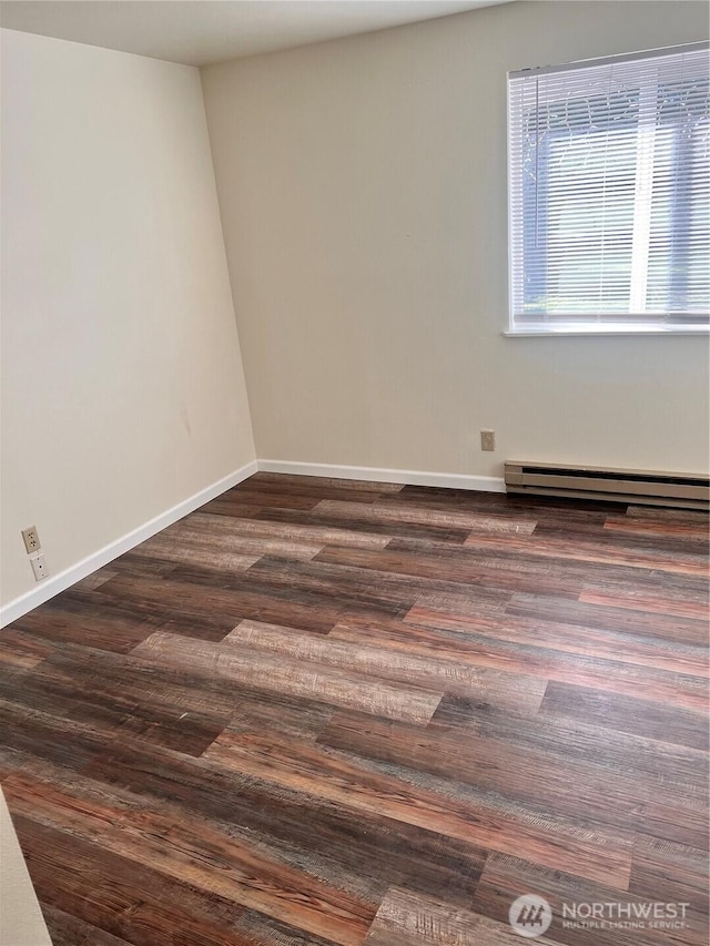 unfurnished room featuring a baseboard radiator, dark wood-type flooring, and baseboards