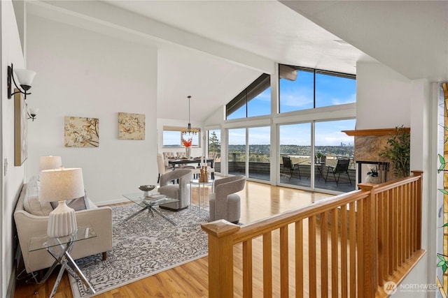 4538 Somerset Dr SE, Bellevue, WA 98006 - living area featuring wood finished floors, high vaulted ceiling, beam ceiling, a notable chandelier, and a multi sided fireplace