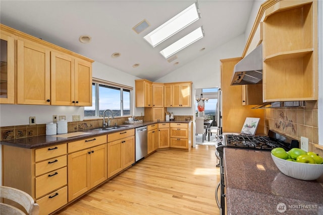 4538 Somerset Dr SE, Bellevue, WA 98006 - kitchen featuring a sink, vaulted ceiling with skylight, under cabinet range hood, light wood finished floors, and appliances with stainless steel finishes