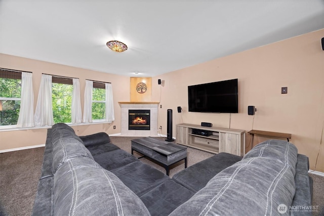 carpeted living area featuring baseboards and a fireplace