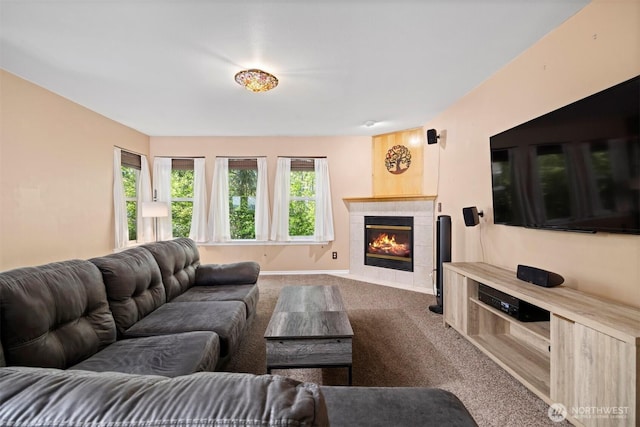 living room featuring carpet flooring, a fireplace, and baseboards