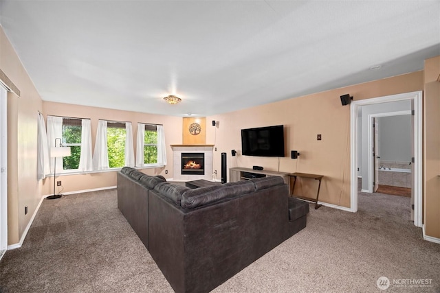 living area with carpet, baseboards, and a tile fireplace