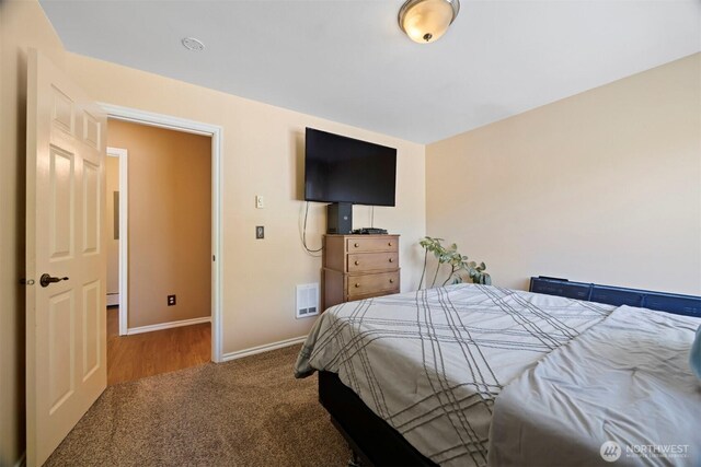 bedroom featuring carpet and baseboards