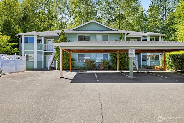 covered parking lot with stairway and fence