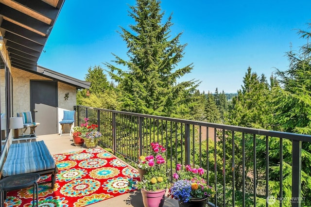 balcony featuring a view of trees
