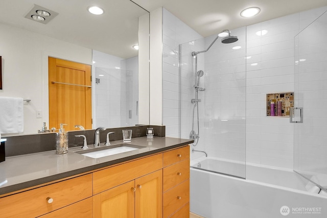 bathroom featuring vanity, tub / shower combination, and recessed lighting