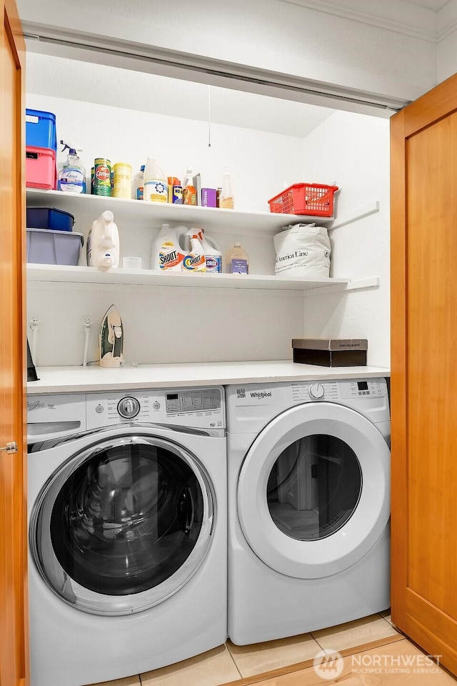 washroom with washing machine and dryer, laundry area, and light tile patterned floors