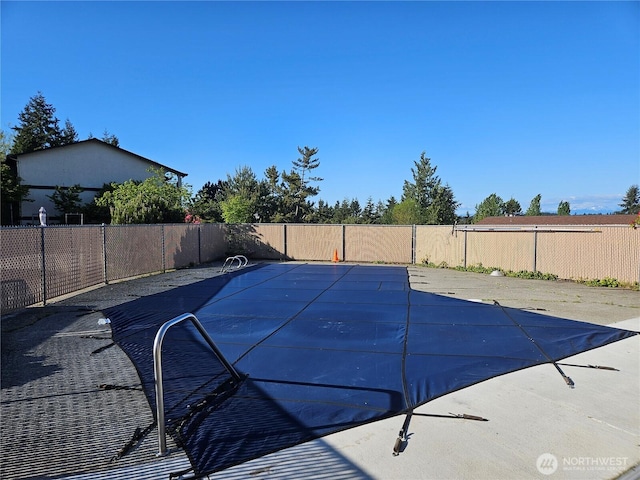 view of swimming pool featuring a patio, a fenced in pool, and a fenced backyard
