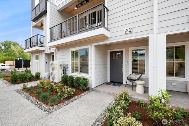 doorway to property featuring ac unit, board and batten siding, and a porch