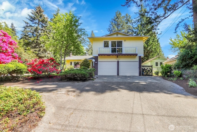 19801 88th Ave W, Edmonds, WA 98026 - view of front of house featuring asphalt driveway, a garage, and a balcony