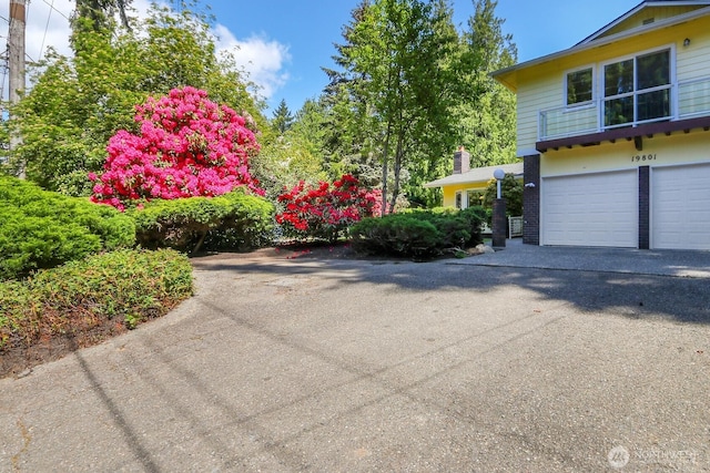 19801 88th Ave W, Edmonds, WA 98026 - view of side of property with an attached garage and driveway