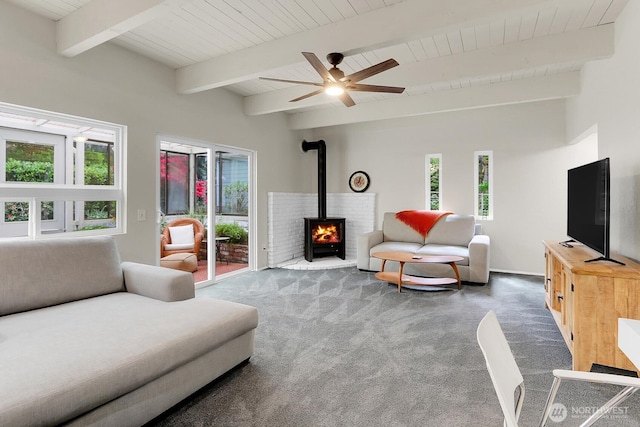19801 88th Ave W, Edmonds, WA 98026 - carpeted living area with plenty of natural light, a wood stove, beamed ceiling, wooden ceiling, and a ceiling fan