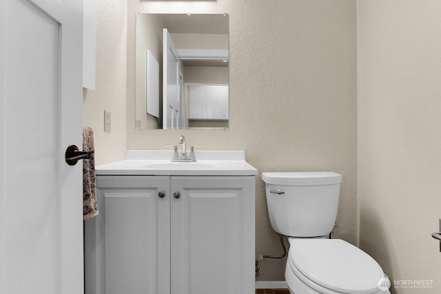 19801 88th Ave W, Edmonds, WA 98026 - half bathroom with vanity, toilet, and a textured wall
