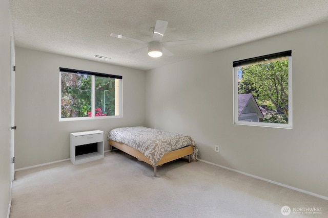 19801 88th Ave W, Edmonds, WA 98026 - bedroom with carpet, a textured ceiling, baseboards, and ceiling fan