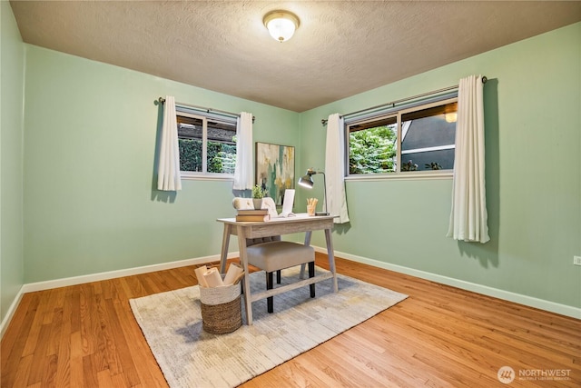 17922 Marine View Dr SW, Normandy Park, WA 98166 - office space featuring baseboards, a healthy amount of sunlight, a textured ceiling, and wood finished floors
