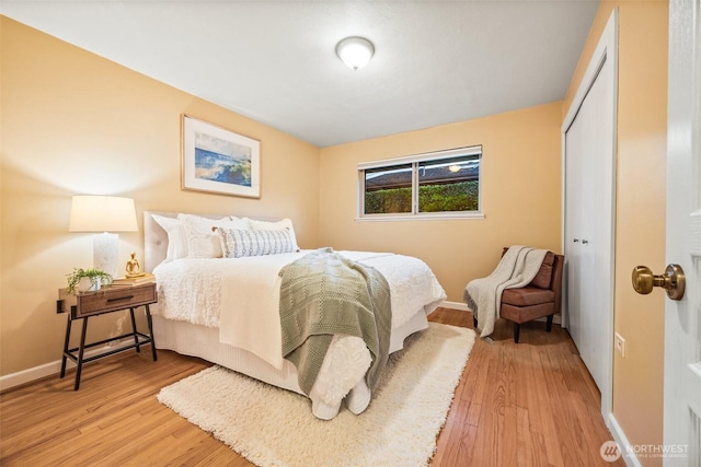 17922 Marine View Dr SW, Normandy Park, WA 98166 - bedroom with a closet, light wood-style floors, and baseboards