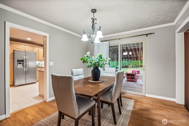 17922 Marine View Dr SW, Normandy Park, WA 98166 - dining area with light wood-style floors, a chandelier, baseboards, and ornamental molding